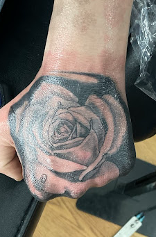 Black & grey rose hand tattoo